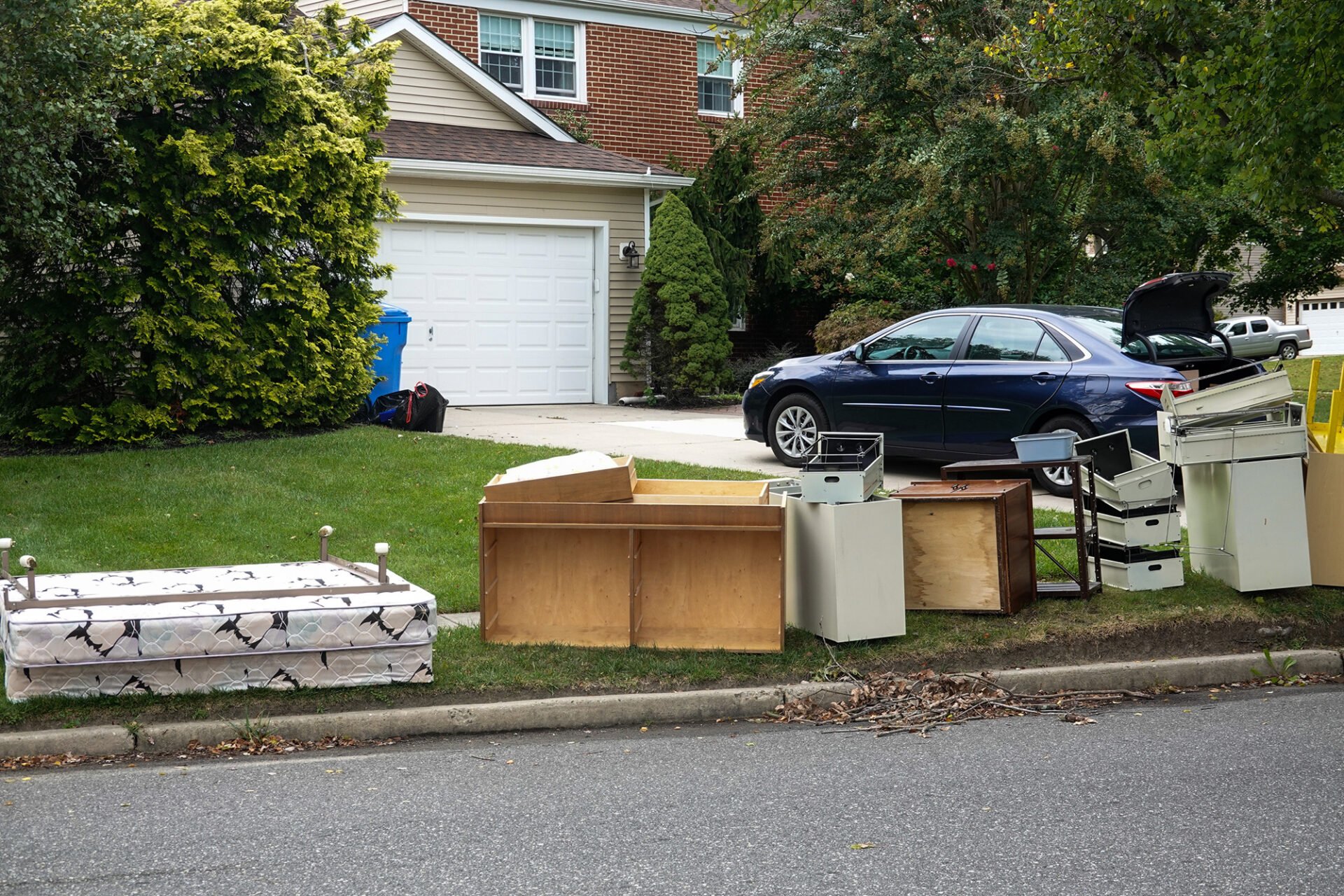 A pile of junk on the curb. Various furniture.