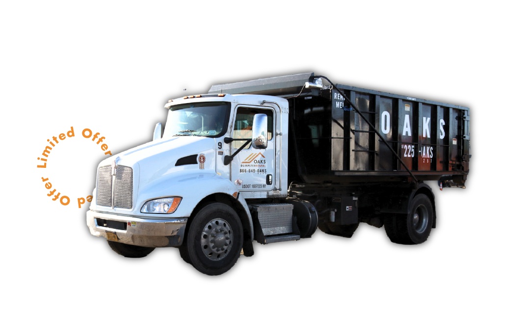 Large Blue Dump Truck with Black Trailer A large blue dump truck with a black trailer. The truck has a silver grill.